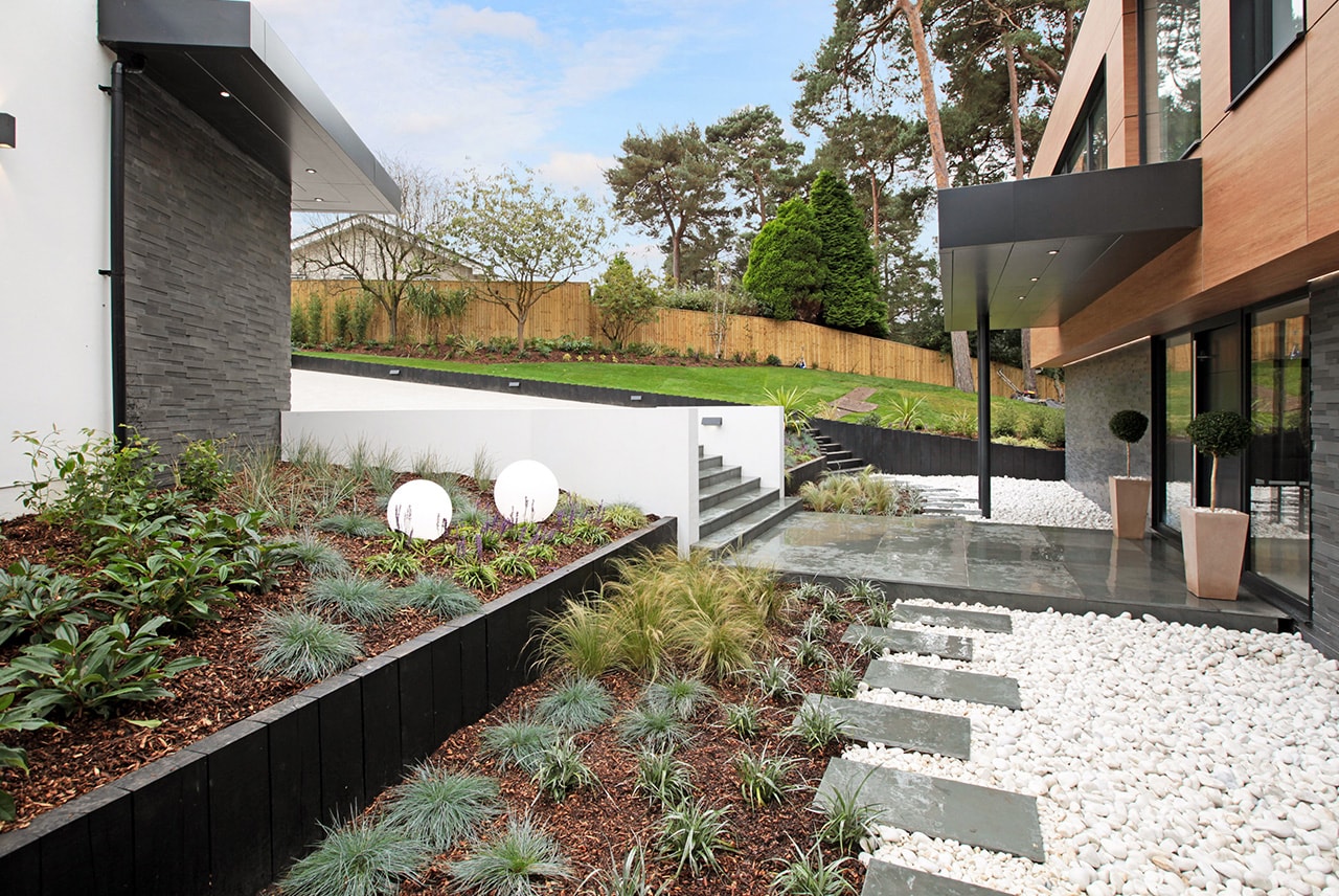 Norstone Aksent 3D Grey Stone Veneer used on two buildings seperated by modern landscaping and hardscaping